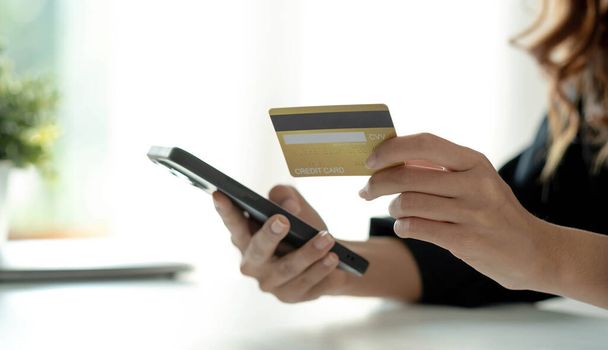 Asian woman checking online order details on smartphone Close control of credit card information entered - Φωτογραφία, εικόνα