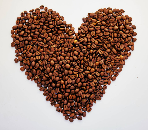 Le cœur veut ce qu'il veut. Tournage de grains de café en forme de coeur. - Photo, image