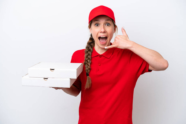 pizza delivery woman with work uniform picking up pizza boxes isolated on white background making phone gesture. Call me back sign - Foto, afbeelding
