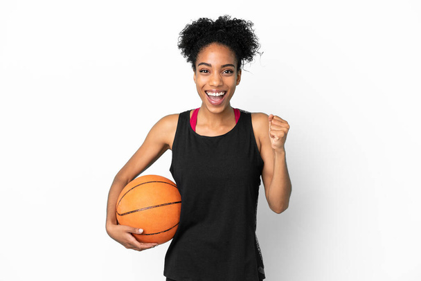 Young basketball player latin woman isolated on white background celebrating a victory in winner position - Foto, imagen