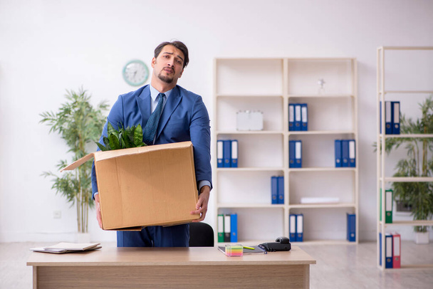 Young male employee in business relocation concept - Fotoğraf, Görsel