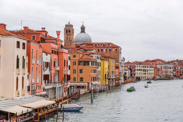 Venice, Italy - April 2, 2022: Beautiful canals and traditional Venetian buildings in Venice, Veneto, Northeast Italy. - Fotó, kép