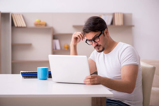 Young male freelancer working from home - Φωτογραφία, εικόνα