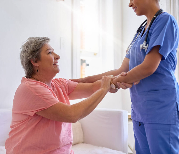 Shes a great helping hand. Cropped shot of a caregiver assisting a senior patient in a nursing home. - Photo, Image