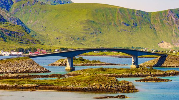 Norwegian scenic landscape on Lofoten archipelago. Road and bridge connecting the islands over the sea. National tourist route 10 Norway. - Fotoğraf, Görsel