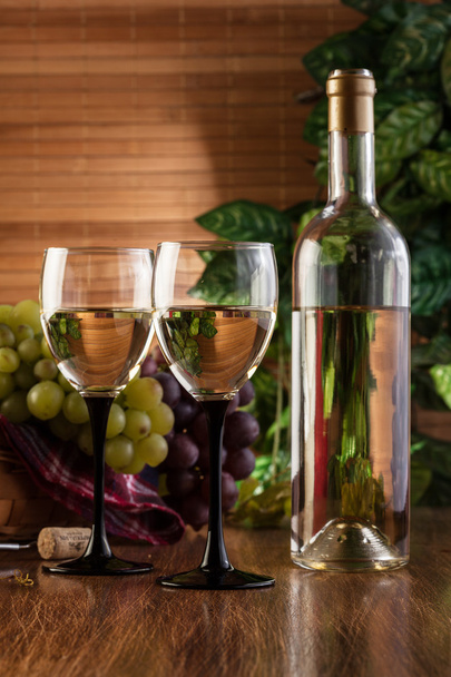 Bottle and glasses of white wine - Photo, image