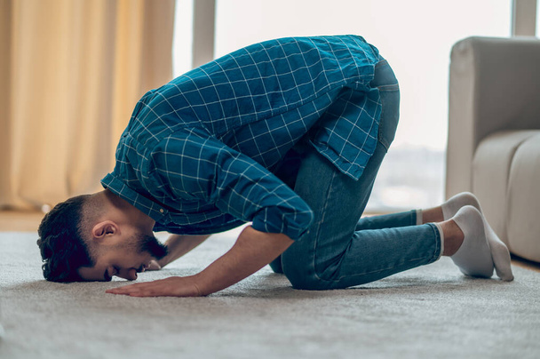 Young muslim praying at home and bowing - Fotó, kép