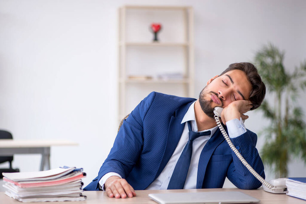 Young male employee extremely tired in the office - Photo, image