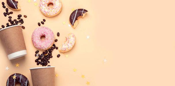 Donuts with coffee on yellow background. Bakery, baking concept. Flat lay, top view, copy space - Fotoğraf, Görsel