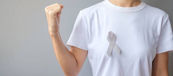 Месяц осведомленности о раке мозга, серый цвет ленты для поддержки людей, живущих. Концепция Всемирного дня борьбы с раком - Фото, изображение