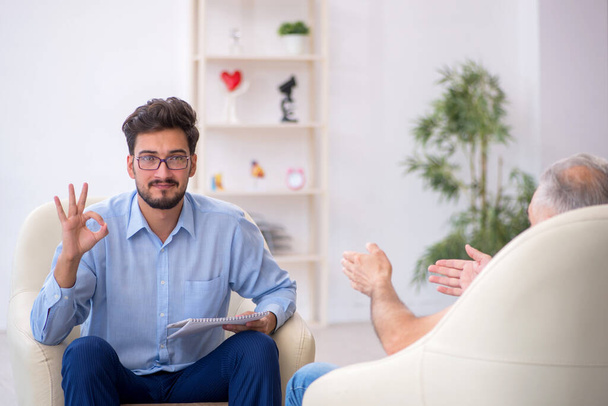 Old man visiting young male psychotherapist - Photo, Image