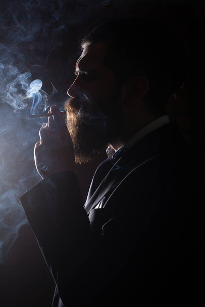 Smoke on black. Man smoking cigarette. Smoker businessman. - Fotoğraf, Görsel