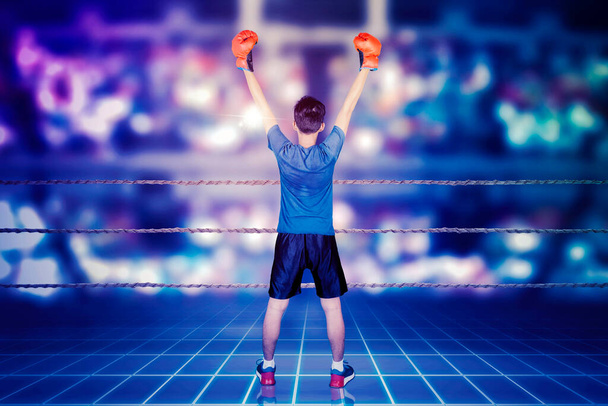 Rear view of male boxer celebrating his winning while standing in the cyberspace with virtual screen background - Фото, зображення