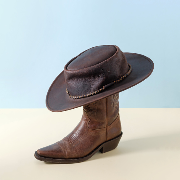 Boot shoes and texas wild west american cowboy hat as minimal concept poster and rural rodeo and farm symbol. - Fotó, kép