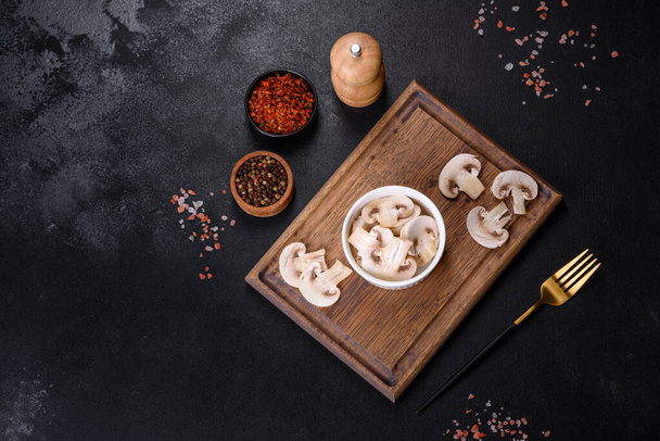 Young champignon mushrooms, sliced into plates, background - Photo, Image