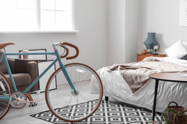 Bicycle in light bedroom interior - 写真・画像