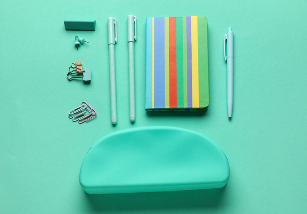 Set of school stationery on turquoise background, top view - 写真・画像