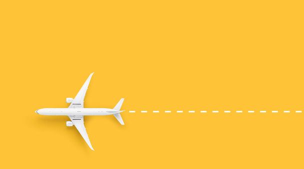 Miniature toy airplane model on yellow background. Flat lay. Directly above. Modern passenger aircraft - Photo, Image