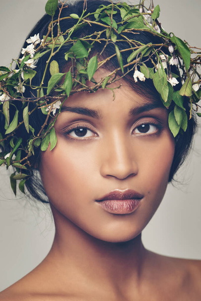 All natural. Studio portrait of a beautiful young woman wearing a head wreath. - Foto, afbeelding