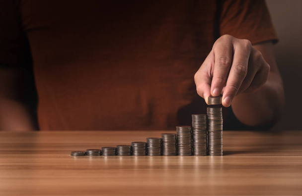 businessman stacking coins. save money and investment growth concept. Savings and pensions, collecting money, financial planning, save money for the future - Photo, Image