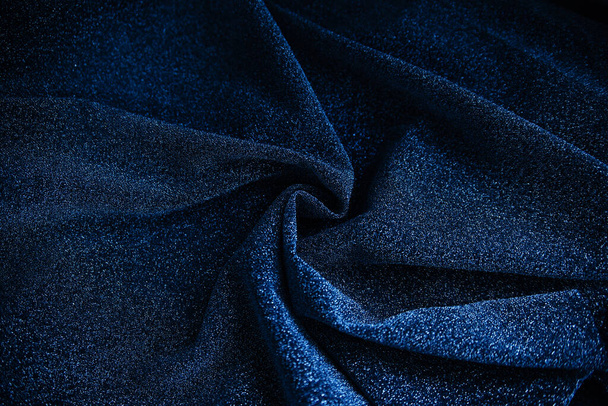Blue wrinkled fabric with sequins.Draped material. Glowing texture - Фото, изображение