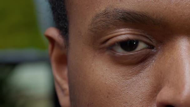 Macro shot of young man showing one eye and half of face - Footage, Video