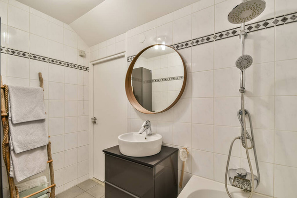 Bathroom interior with white tiles and a pattern on it - 写真・画像