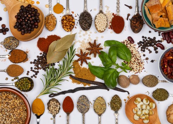 Selection of herbs and cooking spices on spoons. - Foto, imagen