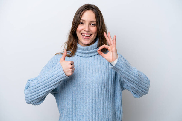 Young caucasian woman isolated on white background showing ok sign and thumb up gesture - Foto, imagen