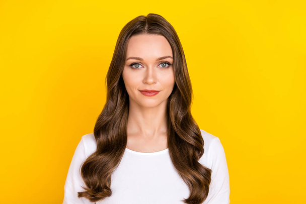 Photo of charming pretty calm lady look camera posing wear white shirt isolated yellow color background - Zdjęcie, obraz
