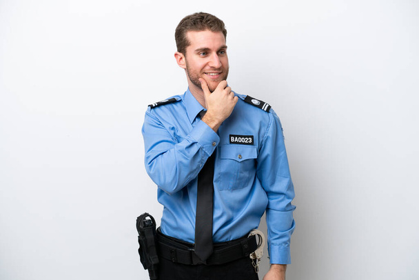 Young police caucasian man isolated on white background looking to the side - Photo, Image