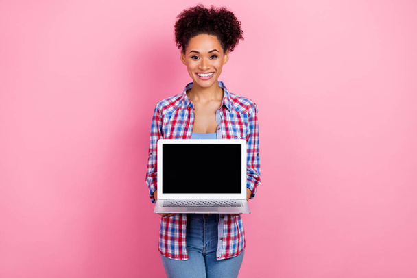 Portrait of attractive cheerful wavy-haired girl holding in hands copy space laptop isolated over pink pastel color background - Φωτογραφία, εικόνα