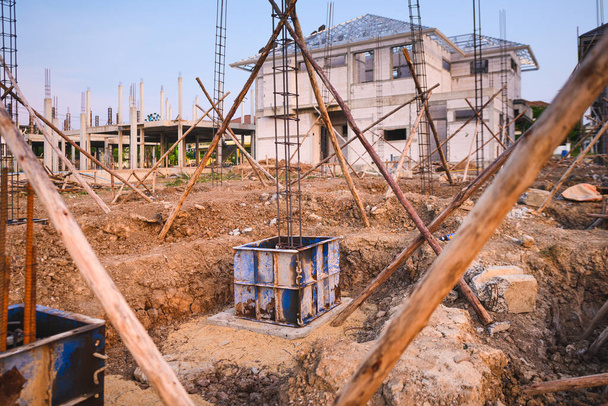 Construction of reinforced concrete foundation with piles to support building weight at site - Фото, изображение