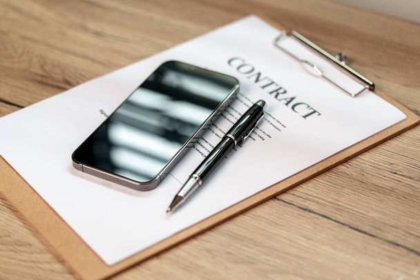 Pen and smartphone signature contract on paperwork background - Photo, Image