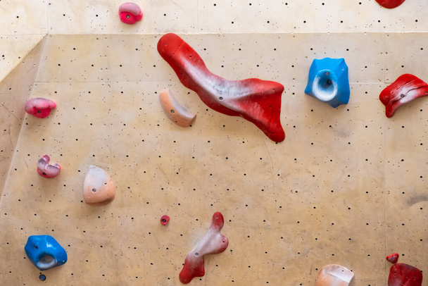 Stone hooks or grips on the artificial climbing wall in bouldering gym  - Foto, afbeelding
