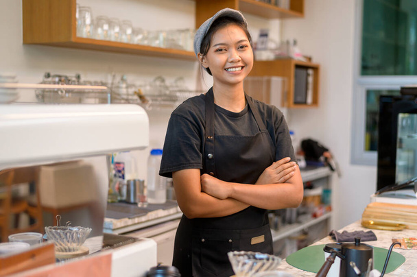 Young service minded barista woman working in coffee shop - Foto, Imagem