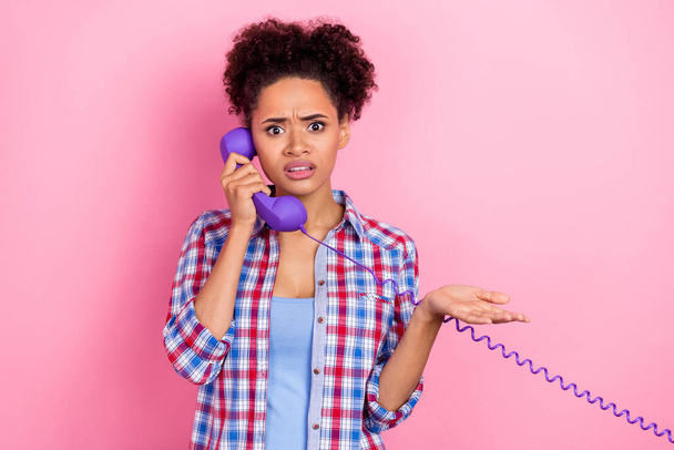 Photo of sad brunette wavy hairdo lady talk telephone wear blue shirt isolated on pink color background - Фото, зображення