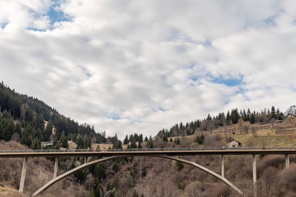 Mesocco, Switzerland, April 3, 2022 Bridge over a valley on the road across the San Bernardino pass - Фото, изображение