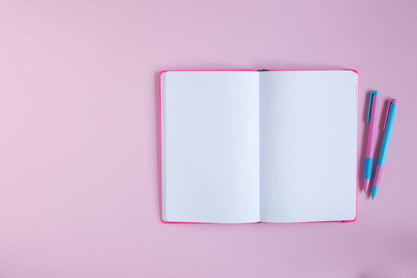 School notebook and stationery on a pink background. - Fotoğraf, Görsel