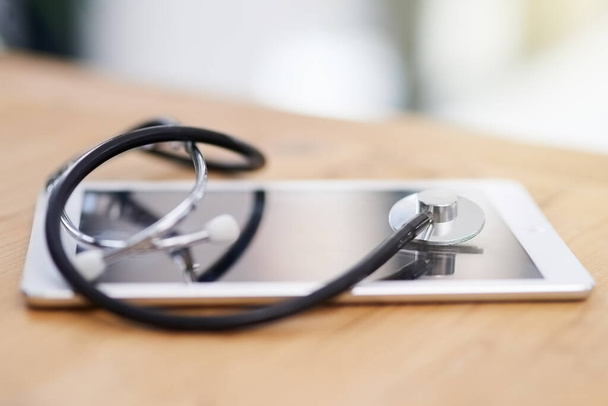 Its important to log your medical history with your practitioner. Cropped shot of a stethoscope on a tablet. - 写真・画像