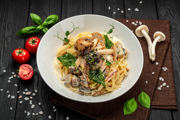 Mushroom Spaghetti Pasta and cream sauce with different types of mushrooms. Serving food in a restaurant. Healthy food concept. Photo for the menu - Photo, Image