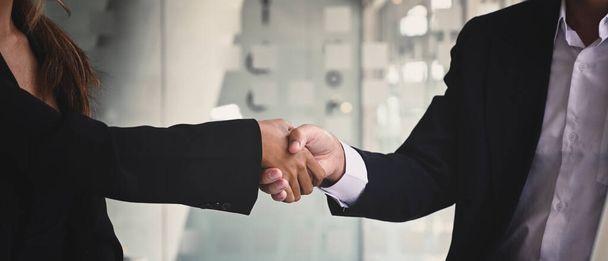 Businesspeople shaking hands after investment deal, finishing up a meeting. Teamwork and partnership concept. - Photo, Image