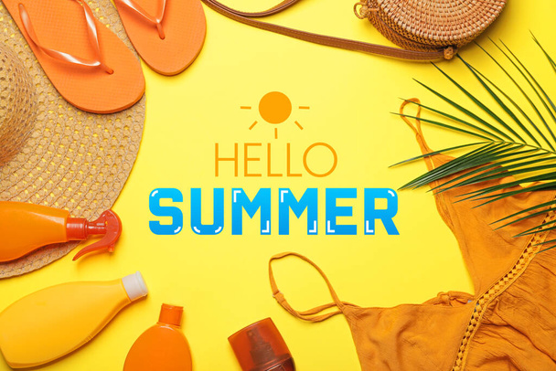Beach accessories with sunscreen cream on yellow background. Hello Summer - Photo, Image