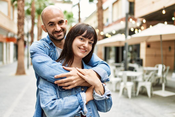 Young hispanic couple smiling happy standing at the city. - Photo, Image