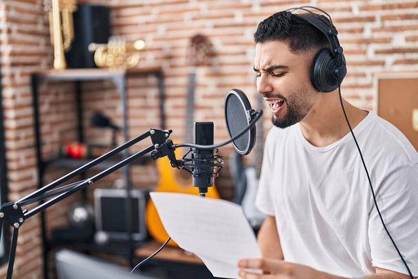 Young arab man artist singing song at music studio - Fotó, kép