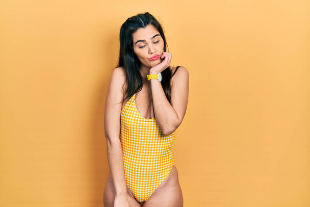 Young hispanic girl wearing swimsuit thinking looking tired and bored with depression problems with crossed arms.  - Zdjęcie, obraz