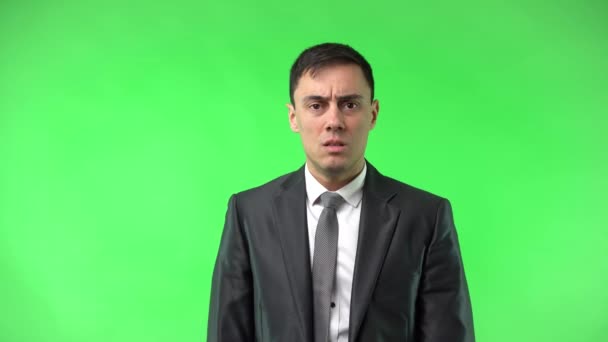 Panicked young man with opened mouth against chroma key - Footage, Video