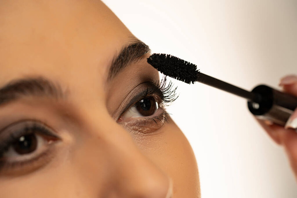 Close up of woman applying mascara - 写真・画像