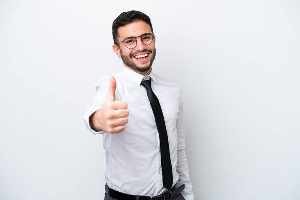 Business Brazilian man isolated on white background with thumbs up because something good has happened - 写真・画像