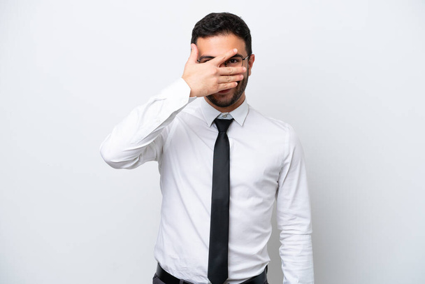 Business Brazilian man isolated on white background covering eyes by hands and smiling - 写真・画像